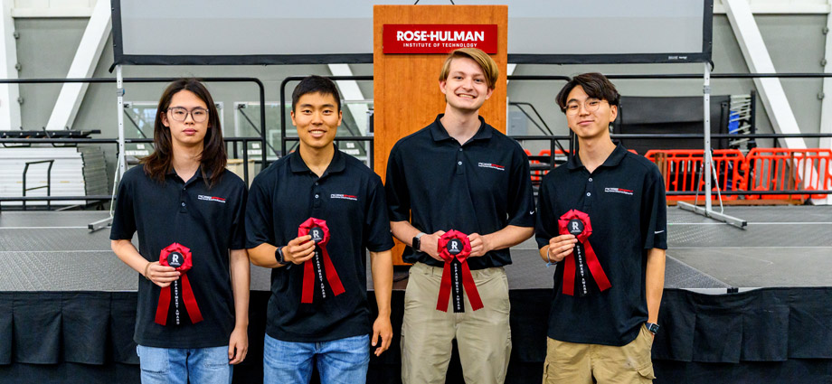 Four students wearing RoseGPE polos hold red award ribbons.