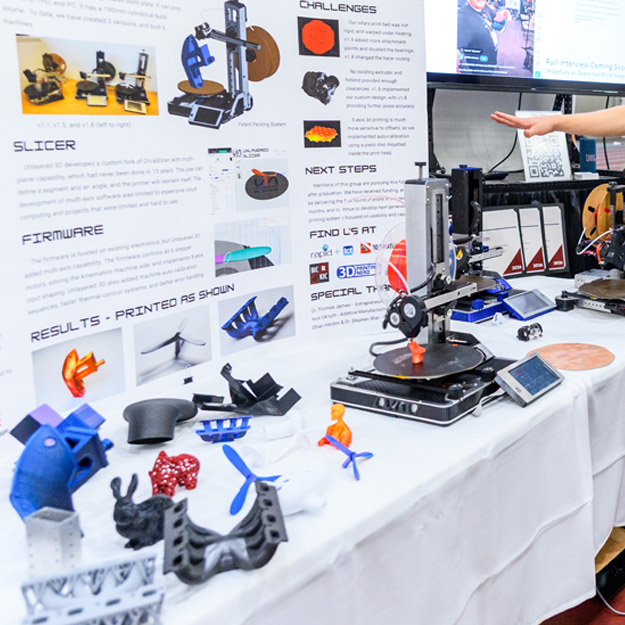 A student explains the Unlayered project, a 3D printer that prints without supports. 