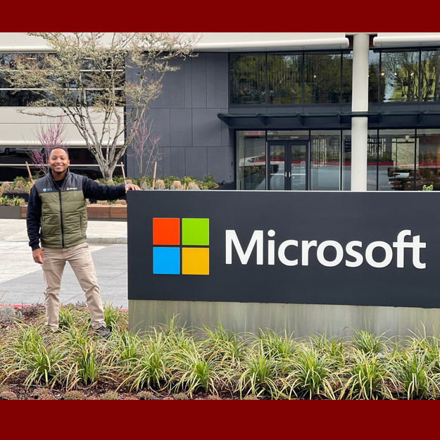 Jeremiah Tate beside a Microsoft sign outside the company headquarters.
