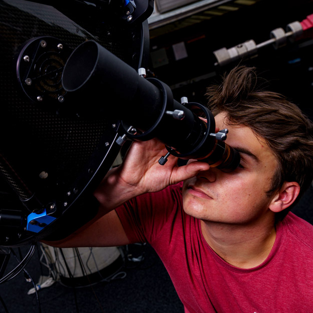 A telescope points toward the night sky.