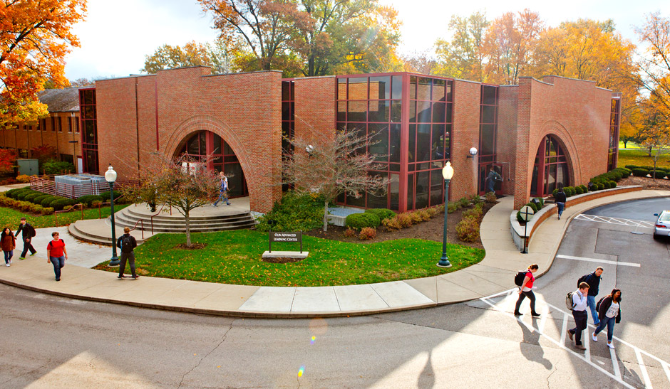 New Olin Hall seen from a significant height with students walking to-and-from the building on a sunny fall day.