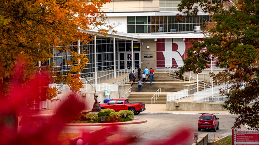 The Sports and Recreation Center exterior view with colorful fall trees in the foreground.