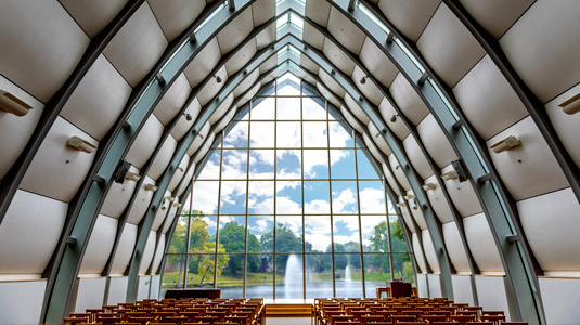 Interior view of White Chapel looking from back toward large window and view of Speed Lake.