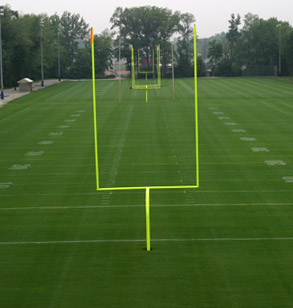 Image shows the bright yellowish-green goal posts on the Intramural Football fields. The elevated view is from behind the end zone.